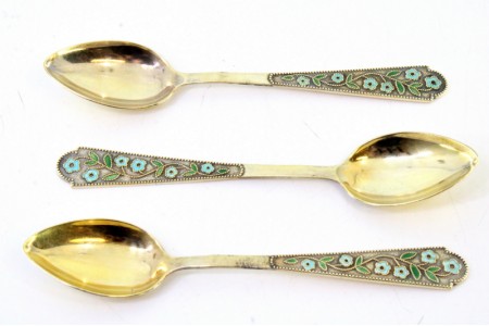 Conjunto de três colheres de chá em prata dourada com cabos perlados e flores esmaltadas.